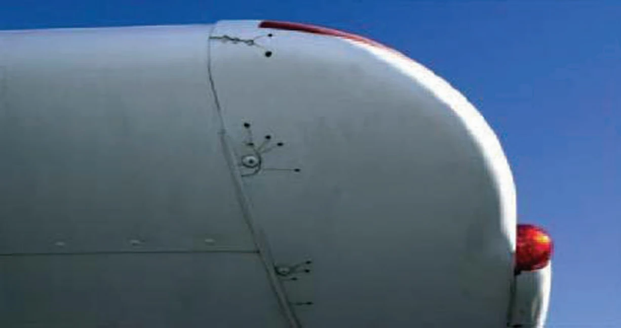 Figure 2-8. Cracks radiating from screw holes that have been stop-drilled to prevent crack progression.